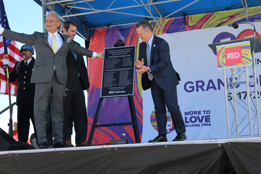 RTD board chair Doug Tisdale, RTD CEO Dave Genova and RTD board member Ken Mihalik reveal a plaque dedicated to the collaborators of the Southeast Rail Extension project, which opened officially May 17.